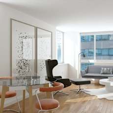 A modern living room with a glass table and chairs.