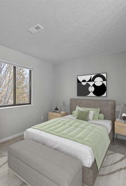 A bedroom with a bed, nightstand, and dresser.