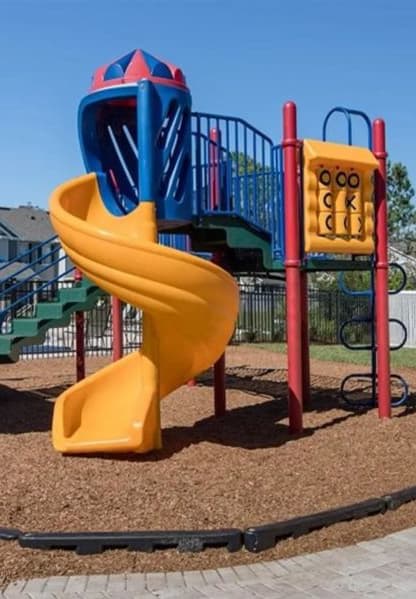 a playground with a yellow and blue slide
