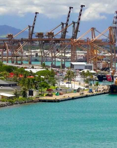 a view of a port with cranes and a body of water