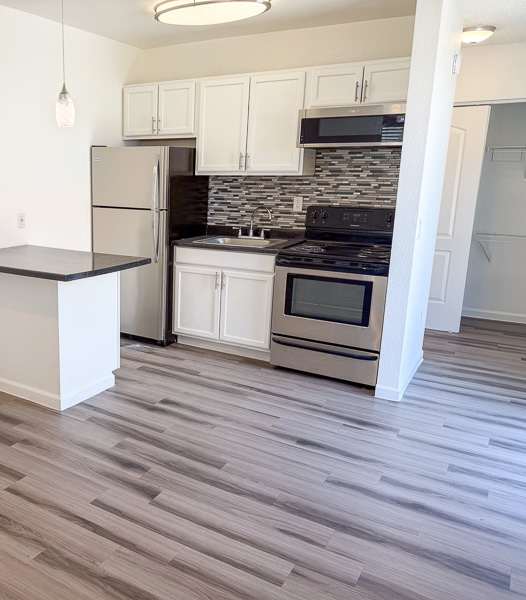 Fifteen 50 modern kitchen with a black countertop and a stainless steel sink.