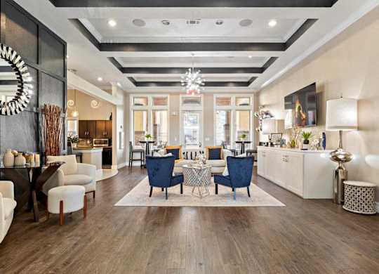 A modern living room with a dark wood floor and a mix of white and dark furniture.