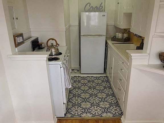 a small kitchen with a refrigerator and a stove