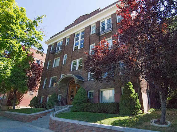 a brick building with a tree in front of it