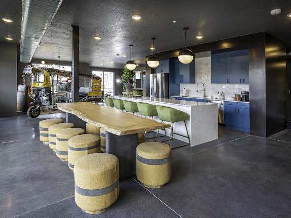 a kitchen with a communal table and stools