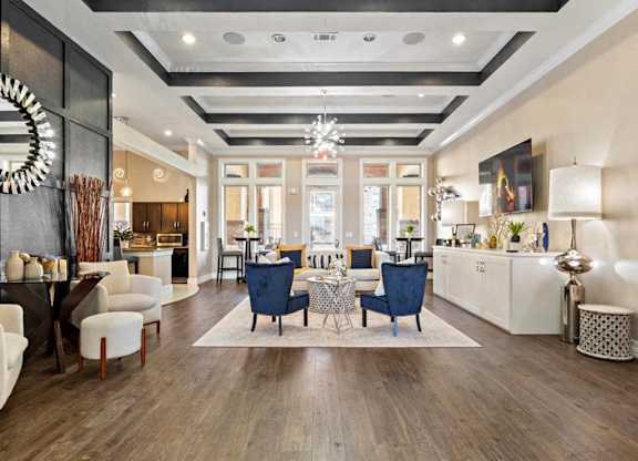 A modern living room with a dark wood floor and a mix of white and dark furniture.