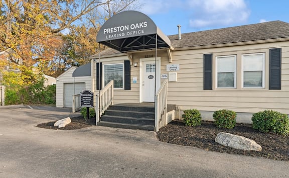 is a tan building with a black roof