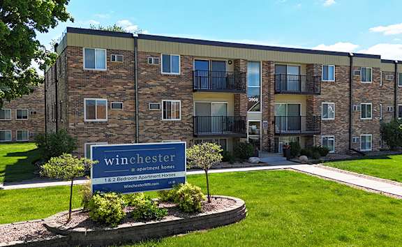 A building with a sign that says Winchester in front of it.