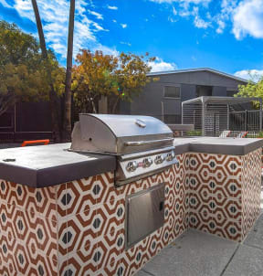 a barbecue grill sitting on top of a sidewalk