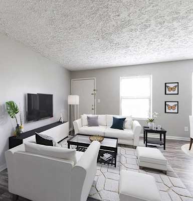 an open living room with white furniture and a tv