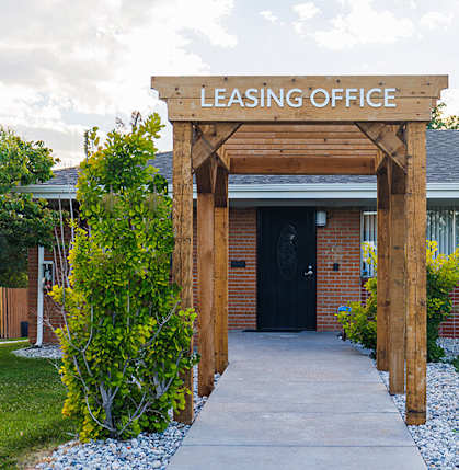 A leasing office is surrounded by a small garden.