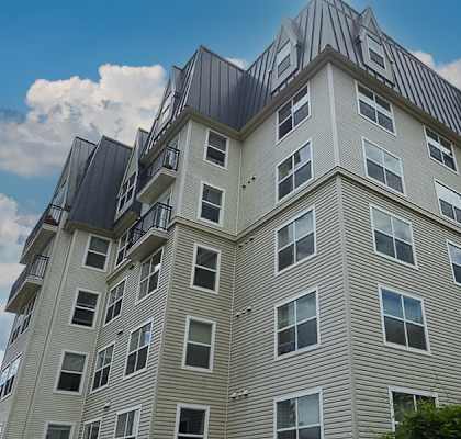 A tall building with a lot of windows and balconies.