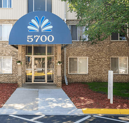 a brick building with a blue sign that says 5700