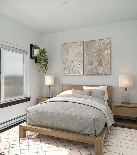 A bedroom with a large bed and two lamps.