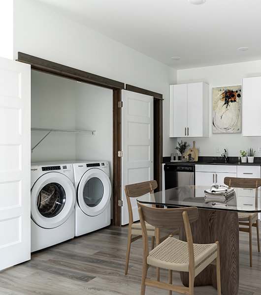 A modern kitchen with a dining table and chairs.