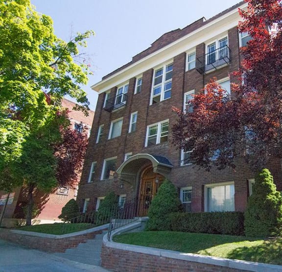 a brick building with a tree in front of it