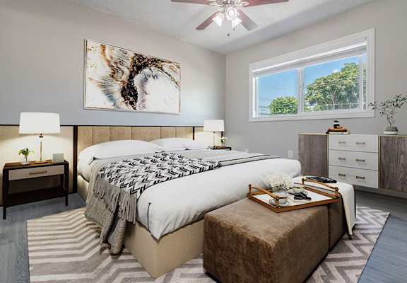a bedroom with a bed and a ceiling fan at Citrus Court Apartments, Whittier, CA