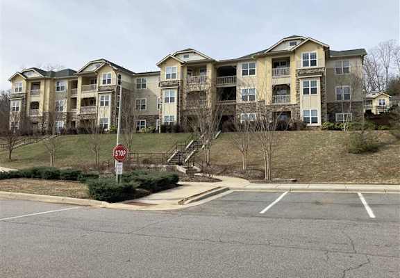 A large apartment complex with a stop sign in front of it.