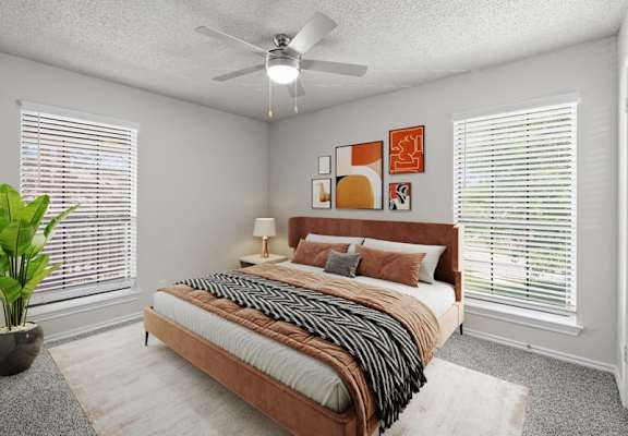 a bedroom with a bed and a ceiling fan