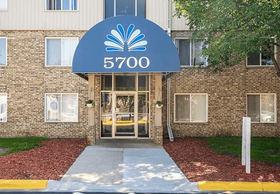 a brick building with a blue sign that says 5700