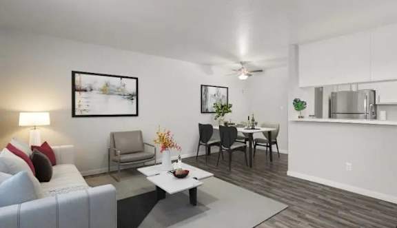 A modern kitchen with a white countertop and a stainless steel sink.