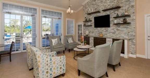 a living room filled with furniture and a flat screen tv