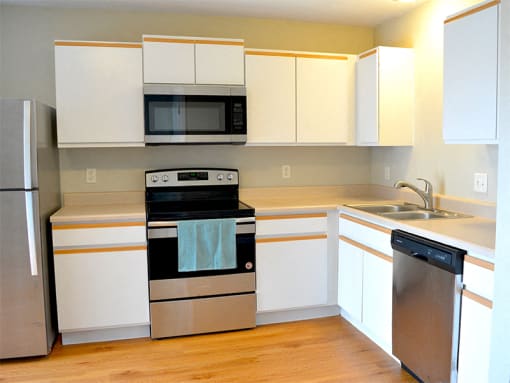 Updated kitchen with stainless steel appliances and hardwood flooring