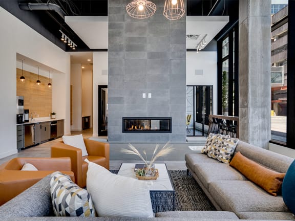 a living room with a gray couch and a fireplace