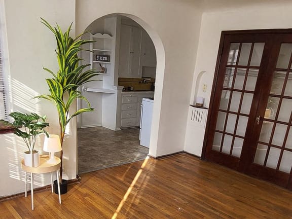 a living room with a wooden floor and a door