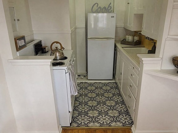 a small kitchen with a refrigerator and a stove