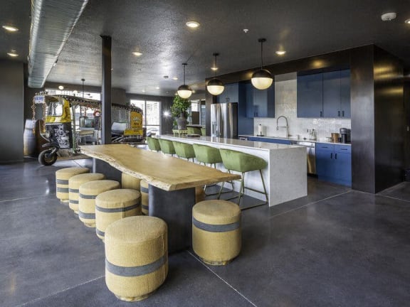 a kitchen with a communal table and stools