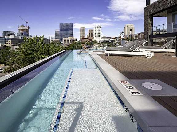 A rooftop pool with a city skyline in the background.