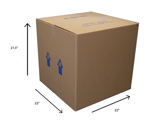 A group of cardboard boxes of various sizes are stacked and leaning against a wall.