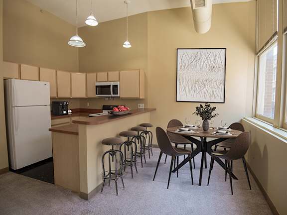A kitchen with a table set for a meal.