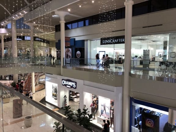 a view of a shopping mall from the top of a escalator