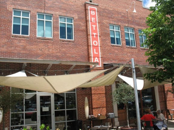 the front of a restaurant with umbrellas in front