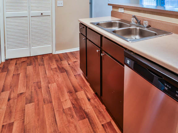 Full kitchen with the dishwasher at Irving apartments that accept cosigners