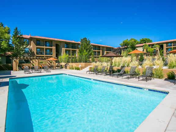 Outdoor Swimming Pool with Sundeck and Lounge Area at Paseo Del Rio Apartments For Rent in Albuquerque, NM