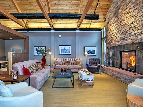 Spacious Resident Clubhouse Media Room with Seating and Fireplace at 80501 Apartments Near Me