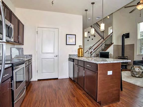 Erie CO Apartments with Large Kitchen with Breakfast Bar, Wood Floors, Granite Counters