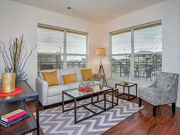 Living Room Area with Large Triple Glazed Windows that Reduce Sound Apartments in Firestone CO