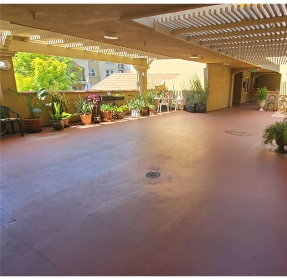 an empty patio with potted plants in a building at KLIMPEL MANOR Apartments, Fullerton, CA