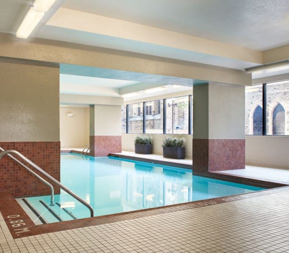 Indoor pool with surrounding seating and lounge areas.