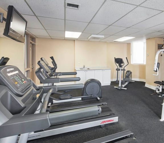 Gym with treadmills, elliptical, stationary bike and weight machines.