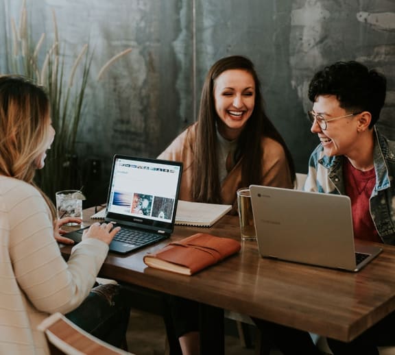 A group of students studying and laughing together.