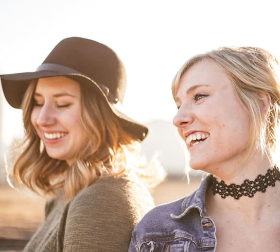 Two females outside smiling.