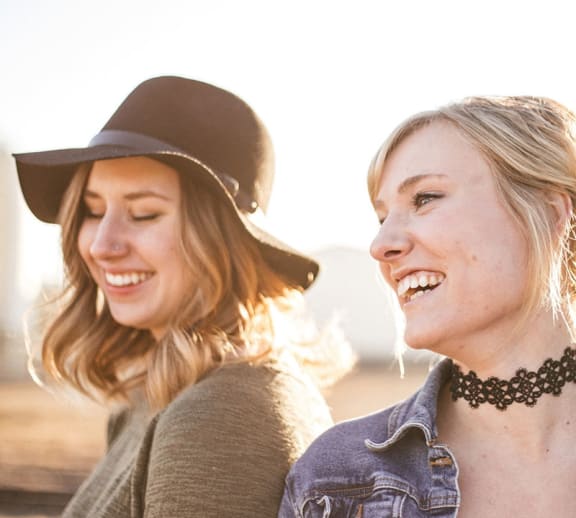 Two females outside smiling.