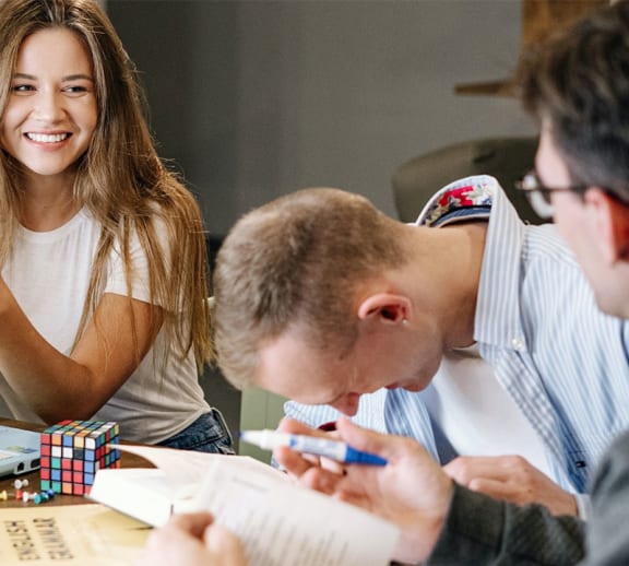 A group of students laughing and socialising together.