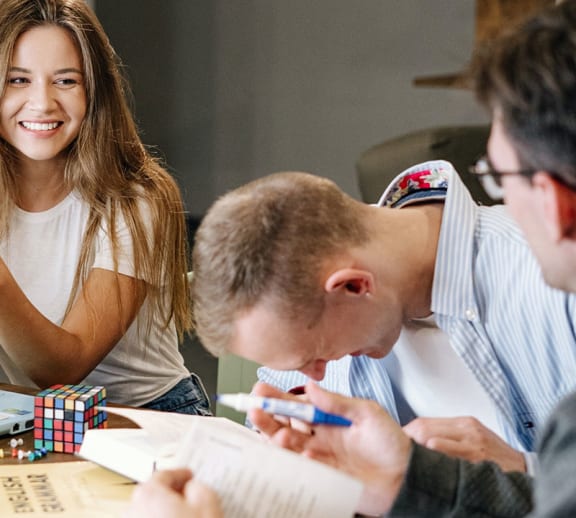 A group of students laughing and socialising together.