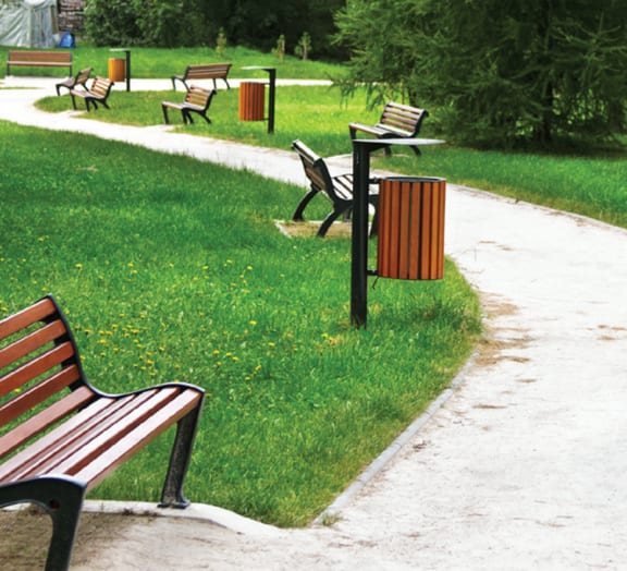 park benches and trash cans in a park
